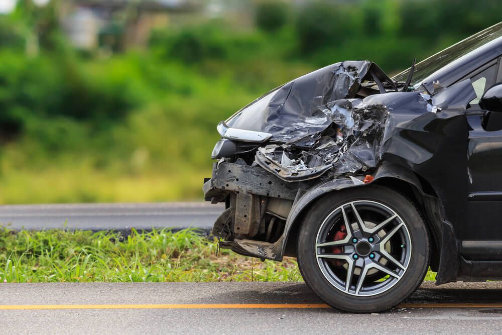 Smashed up black car