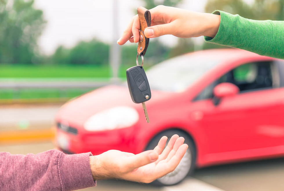 Handing car keys to someone