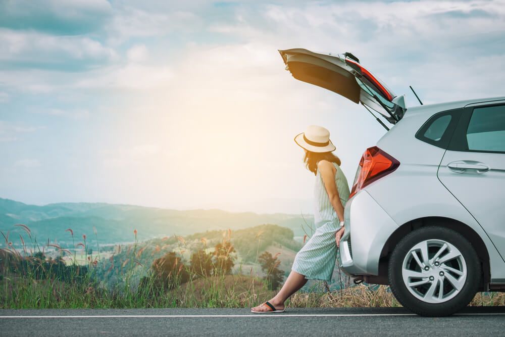 Woman leaning on cars