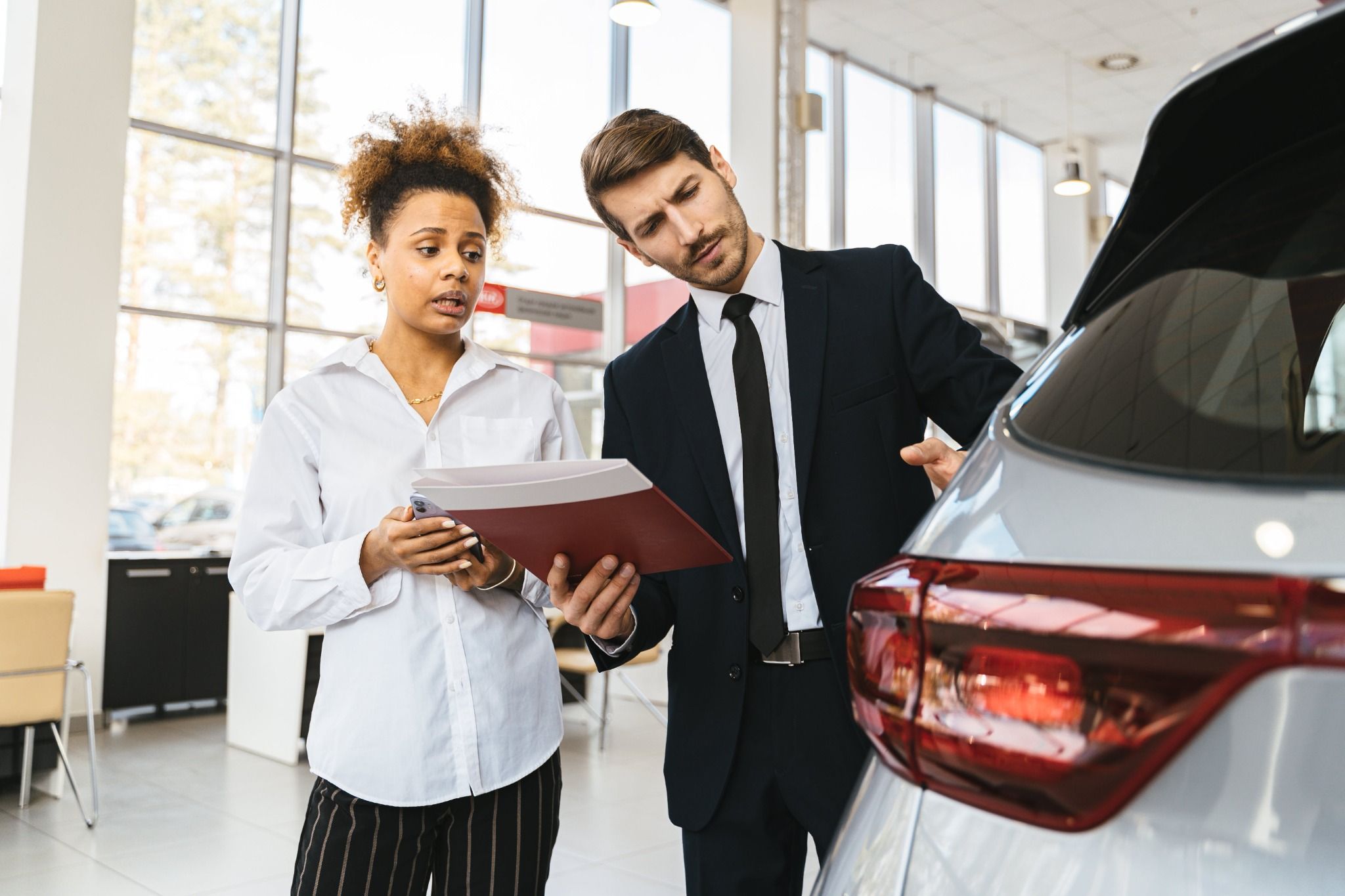 People looking at a car