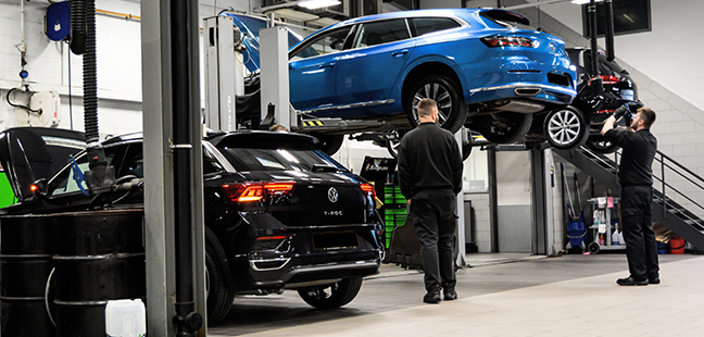 Volkswagen workshop interior view with car on ramps